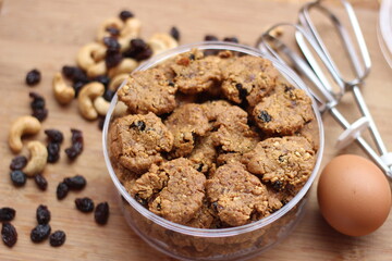chocolate cookies with raisins and peanuts on a wooden table