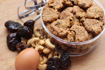 chocolate cookies with raisins and peanuts on a wooden table