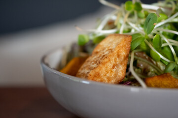 Salad vegetable with fried tofu in white bowl