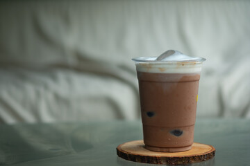 A glass of cold ice coffee mocha with ice ball cubes