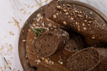 Close-up of a baguette of black bread with seeds
