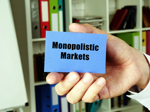 Financial concept about Monopolistic Markets with inscription on the blue business card.