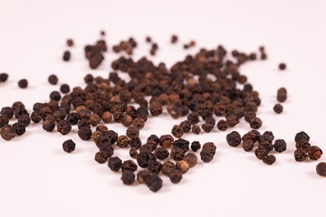 black and brown pepper balls are scattered close to each other