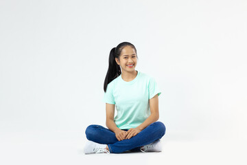 Happy asia woman sitting on floor and looking at camera
