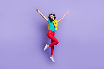 Fototapeta na wymiar Full length photo of charming shiny wavy woman dressed pullover shoulders jumping rising hands isolated purple color background