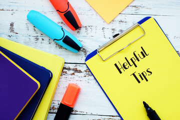 Financial concept about Helpful Tips with inscription on the piece of paper.