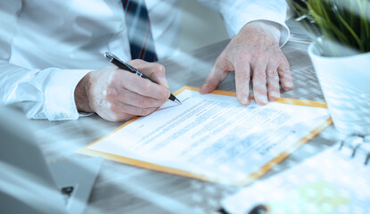 Hand of businessman signing a document; light effect