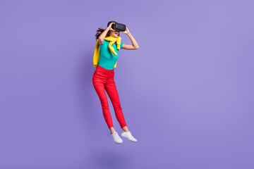 Full length photo of funny wavy young woman dressed pullover shoulders vr eyeglasses jumping isolated purple color background