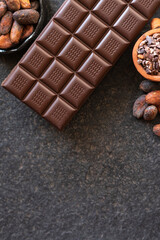 Chocolate, cocoa beans, cocoa slices on a black background
