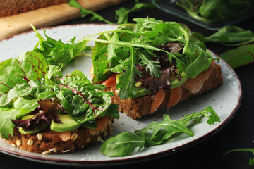 Sandwiches with salmon, avocado and salad