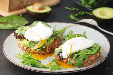 Homemade sandwiches with salmon, avocado and poached eggs