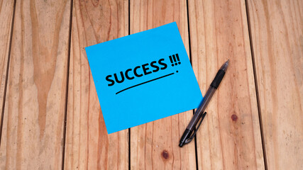 Success quotes in blue paper on top table. Business concept. Still life