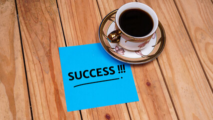 Success quotes in blue paper on top table. Business concept. Still life