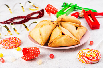 Purim celebration background. Jewish carnival. Traditional jewish hamantaschen cookies cakes and...