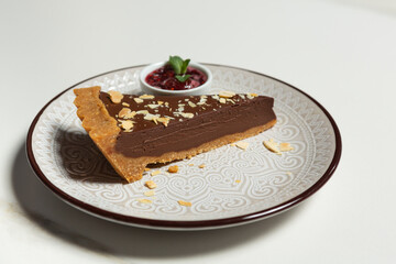 Chocolate cake pie served with raspberry jam in the plate