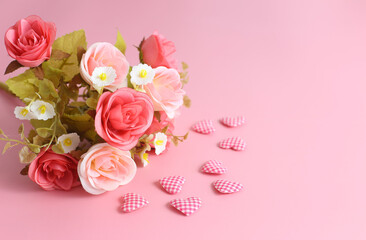 Love background - bouquet of rose and heart shape on pink background