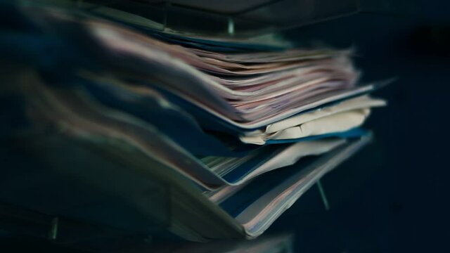Archived papers, documents, files in a drawer. Stack of old papers, unsolved.