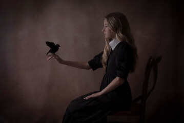 Gothic girl holding a crow