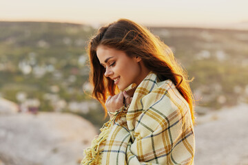 Red-haired woman with fred on nature in the mountains smiling model side view