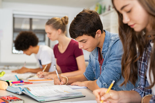 High school students doing exam in classroom - Powered by Adobe