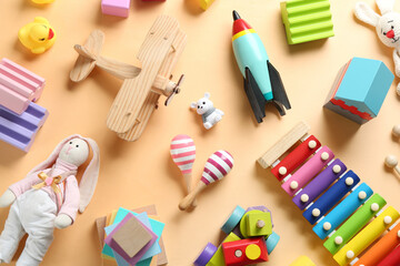 Different toys on beige background, flat lay - obrazy, fototapety, plakaty