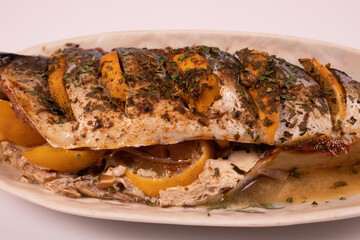 fish stuffed with lemon on a platter side view