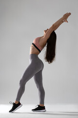 woman doing fitness exercise, isolated, Full length portrait of beautiful young woman doing stretching exercise isolated