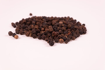 brown and black pepper balls lie tightly to each other