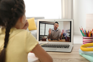 Distance learning, studying at home. Girl having online school lesson with teacher during...