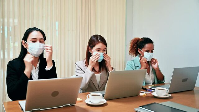 Businesswomen wearing face mask before start conference while coronavirus pandemic