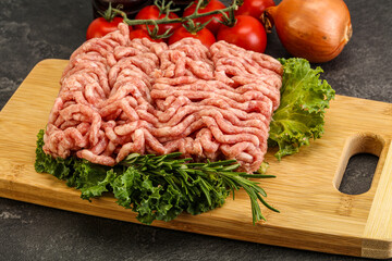 Raw pork minced meat over board