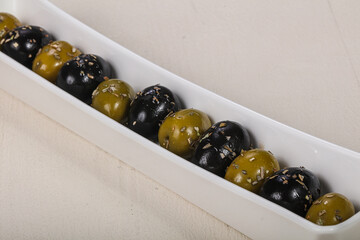 Black and green olives in the bowl