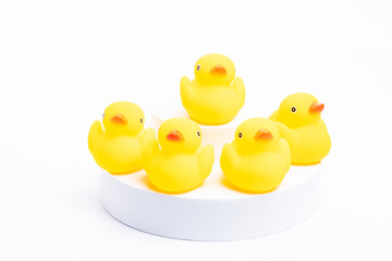 A group of yellow rubber duck following the leader