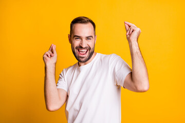Fototapeta premium Portrait of attractive cheerful funky guy dancing having fun chill out party isolated over bright yellow color background