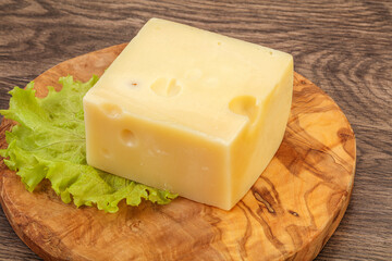 Emmental cheese over wooden board
