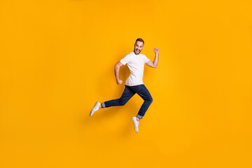 Fototapeta na wymiar Full length body size photo of jumping man wearing casual clothes isolated bright yellow color background