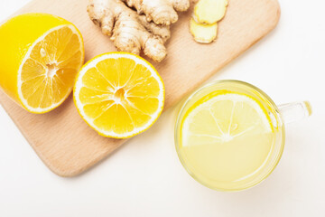 Top view cup of lemon ginger lemonade and ingredients on cutting board