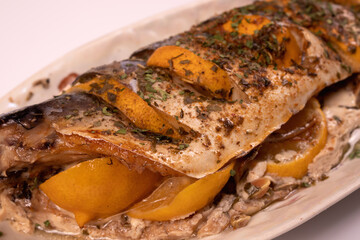 fish stuffed with lemon on a platter, diagonal view