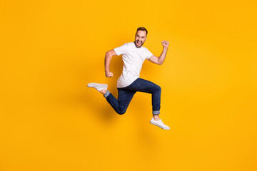 Fototapeta na wymiar Full length body size photo of jumping cheerful male model wearing stylish outfit isolated vivid yellow color background