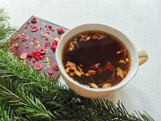 cup of tea and Chocolate bar with seeds and berries. concept winter greeting post card 