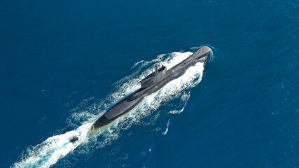 Aerial drone photo of latest technology naval armed forces submarine cruising in deep blue open...