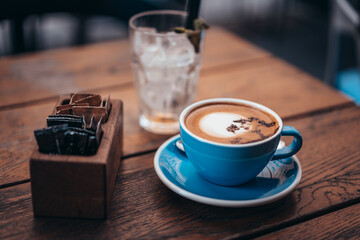 Beautiful coffee on table with tree made in milk foam 