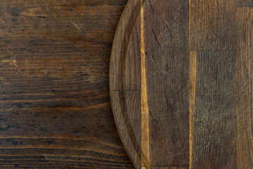 Cutting board or kitchen board on a wooden background. Space for text.