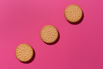 Sweet cookies flat lay pattern on lpink background.