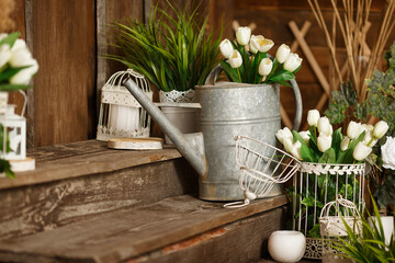 Spring greenery and flowers, a pot with green plants. Beautifully decorated farmhouse look. Rustic...