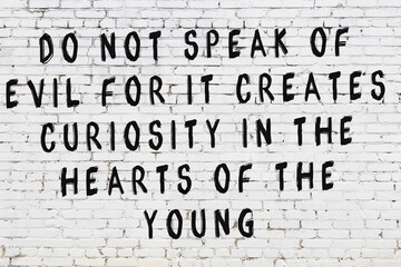 Black painted inscription of smart quote on white brick wall