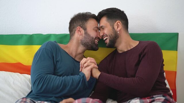 Happy gay couple having romantic moments in bedroom - Homosexual love relationship and gender equality concept