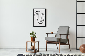 Stylish scandinavian composition of living room with design armchair, black mock up poster frame, plant, wooden stool, book, decoration, loft wall and personal accessories in modern home decor.
