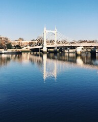 London, UK, November 01, 2020: Relextion of Albert Bridge on the River near Battersea Park in London. Day Light.