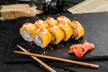 Sushi rolls with cheddar cheese on black background